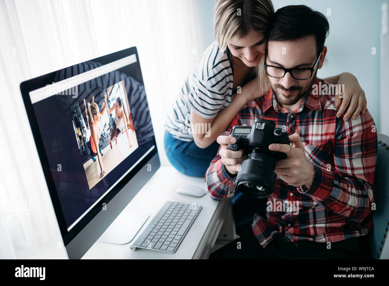 Young attractive designers working on project together Stock Photo