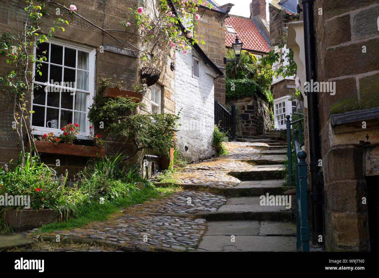 Cobblestone Alley running up through the picturesque fishing village of Robin Hood’s Bay. Stock Photo