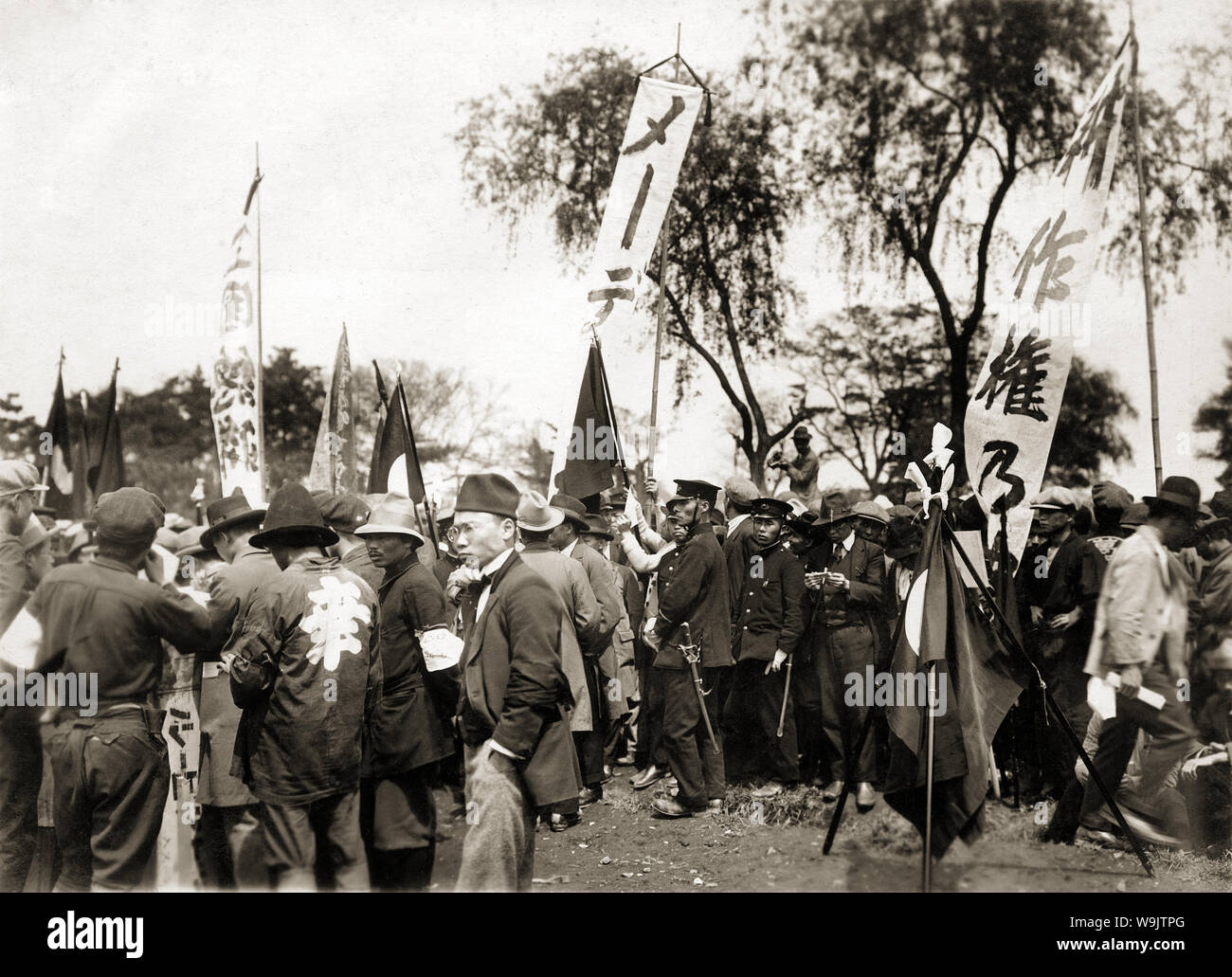 [ 1920s Japan - Japanesse May Day Demonstration ] —   Protestors and police officers at a May Day demonstration.  20th century vintage gelatin silver print. Stock Photo