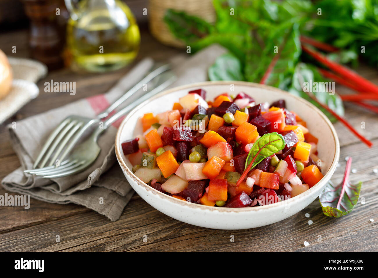 Beetroot or beet salad with boiled vegetables on wooden rustic table closeup Stock Photo