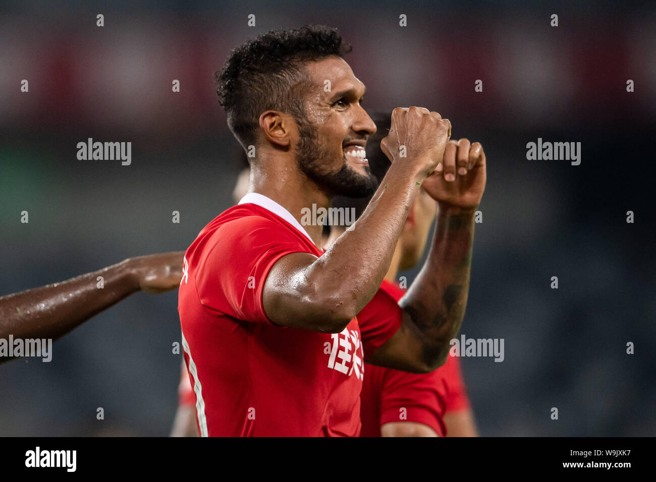 Brazilian-born Portuguese football player Dyego Sousa of Shenzhen F.C. celebrates after scoring against Guangzhou R&F F.C. in the 22nd round match during the 2019 Chinese Football Association Super League (CSL) in Shenzhen city, Guandong province, China, 14 August 2019. Stock Photo