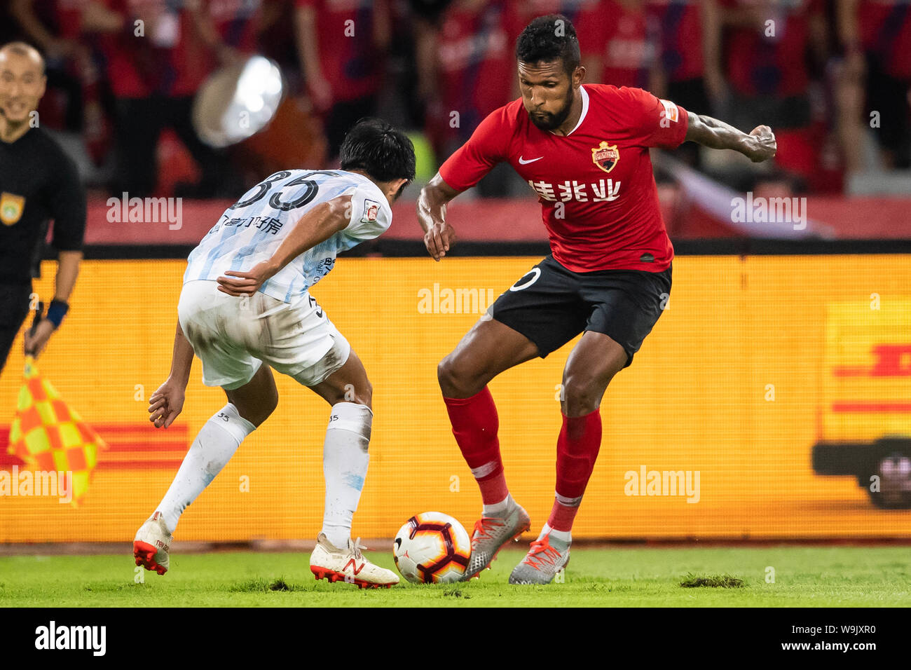 Brazilian-born Portuguese football player Dyego Sousa of Shenzhen F.C., right, chases after the ball in the 22nd round match during the 2019 Chinese Football Association Super League (CSL) in Shenzhen city, Guandong province, China, 14 August 2019. Stock Photo