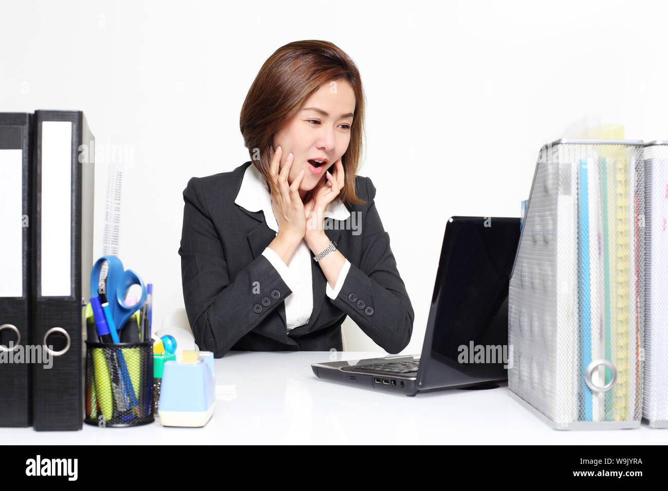 The Asian business woman surprise with her performance from customer Stock Photo