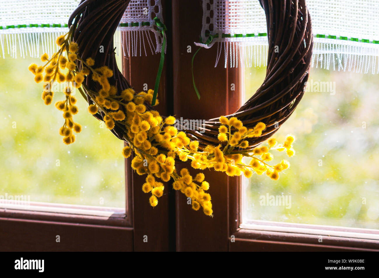 A spring / easter decorative wreath made from pussy willow and decorated with small yellow flowers. Stock Photo