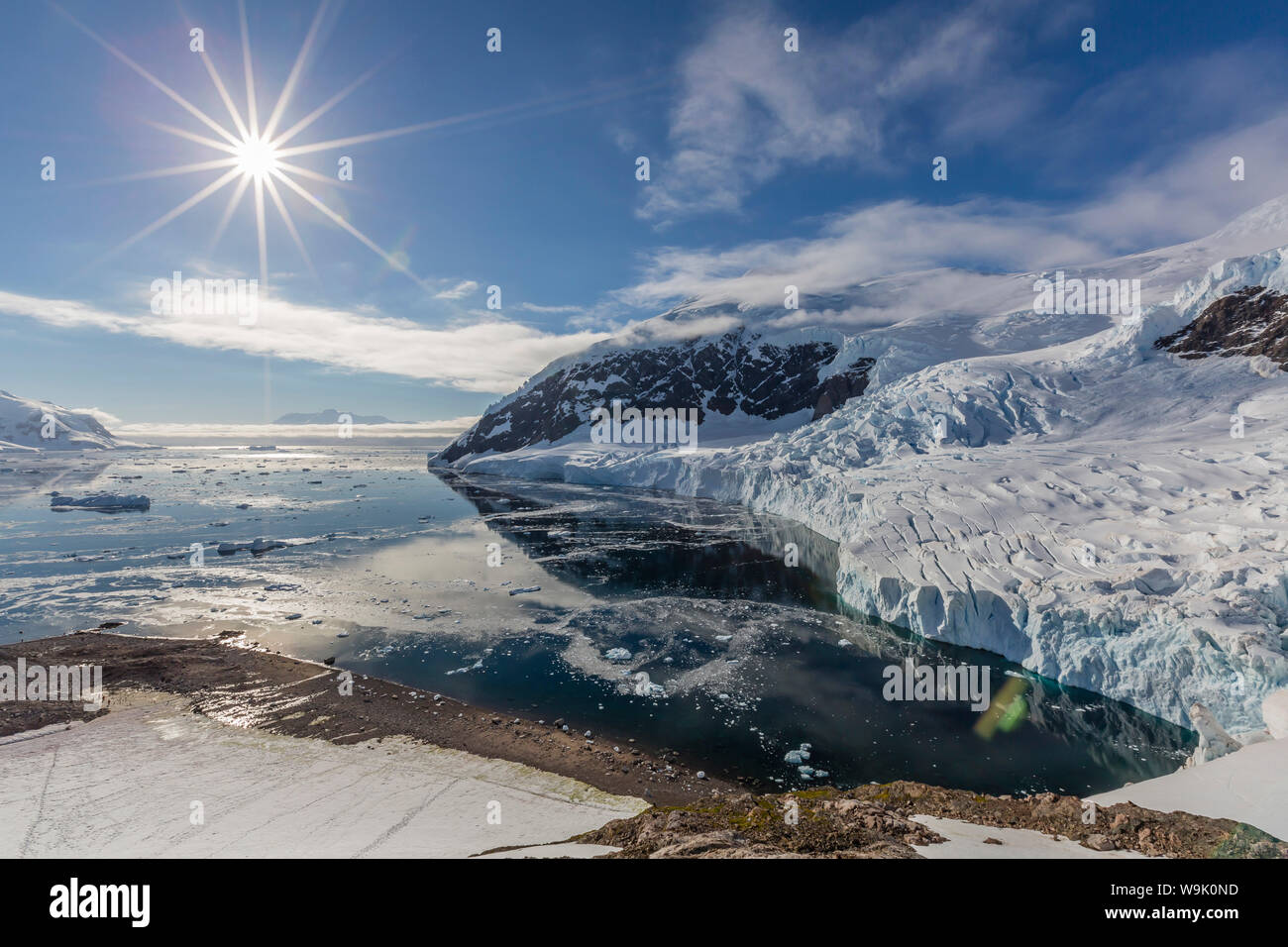 Ice choked waters surrounded by ice-capped mountains and glaciers in Neko Harbor, Antarctica, Polar Regions Stock Photo
