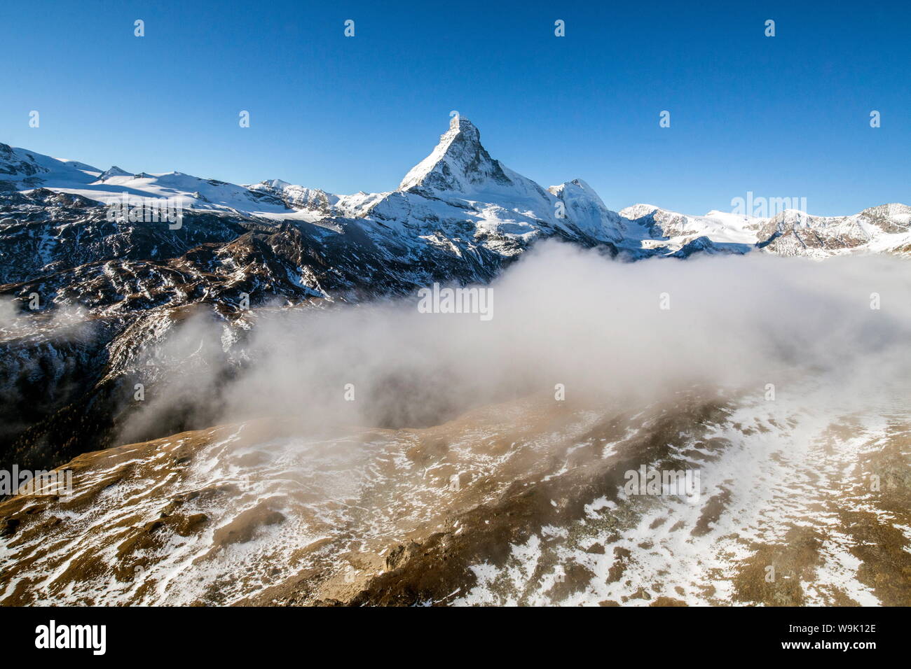 The unique shape of the Matterhorn sorrounded by its mountain range covered in snow, Swiss Canton of Valais, Swiss Alps, Switzerland, Europe Stock Photo