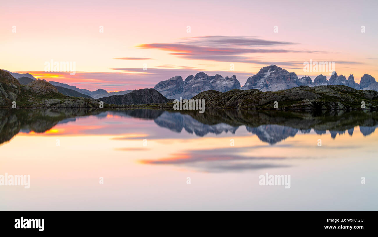 Pink clouds are reflected in Lago Nero at dawn, Cornisello Pinzolo, Brenta Dolomites, Trentino-Alto Adige, Italy, Europe Stock Photo
