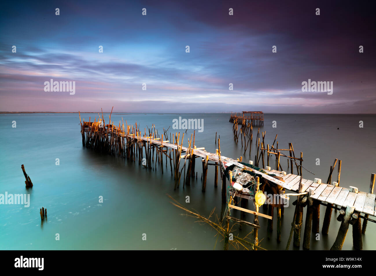 Sunrise and clouds on the Palafito Pier in the Carrasqueira Natural Reserve of Sado River, Alcacer do Sal, Setubal, Portugal, Europe Stock Photo