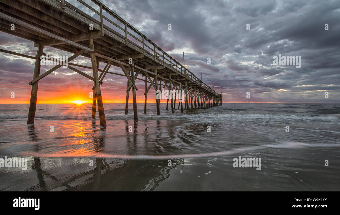 Beach, ocean, waves and pier at sunrise, Sunset Beach, North Carolina, United States of America, North America Stock Photo