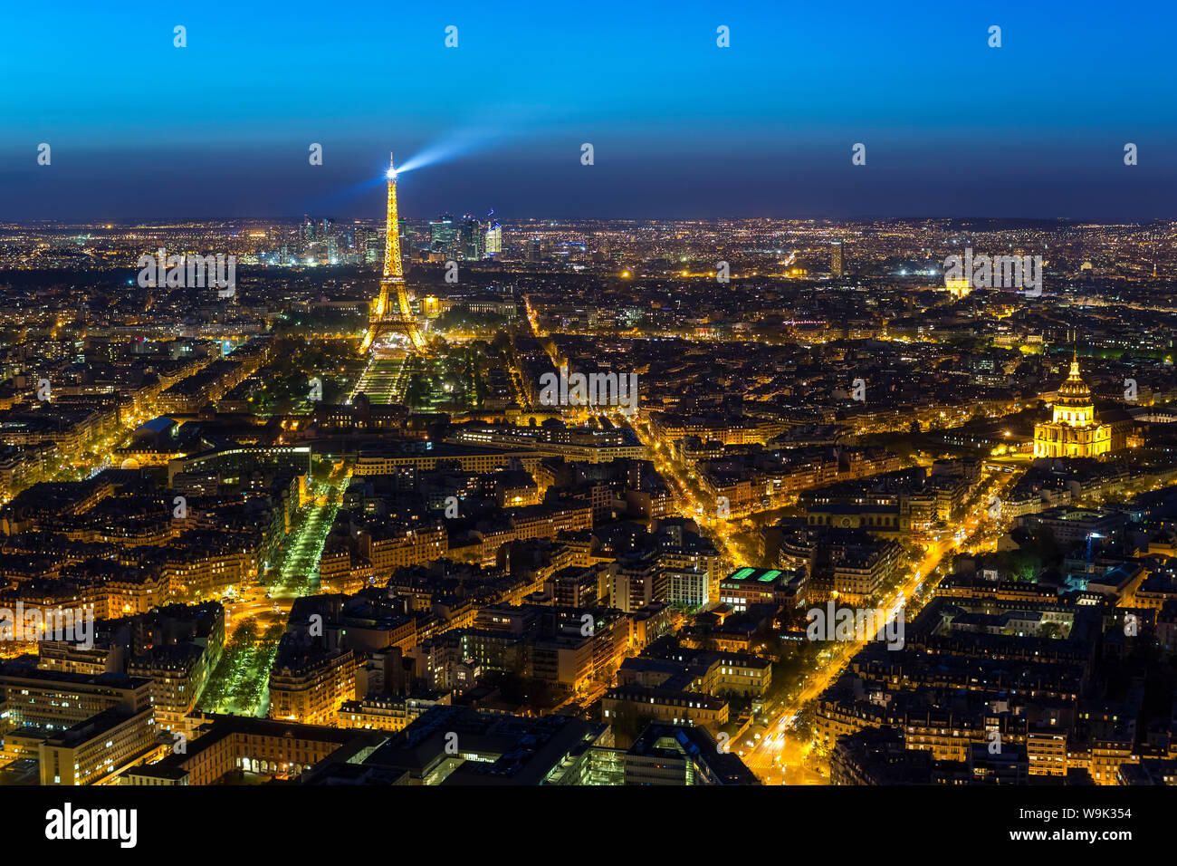 Elevated view of the Eiffel Tower, city skyline and La Defense skyscraper district in the distance, Paris, France, Europe Stock Photo