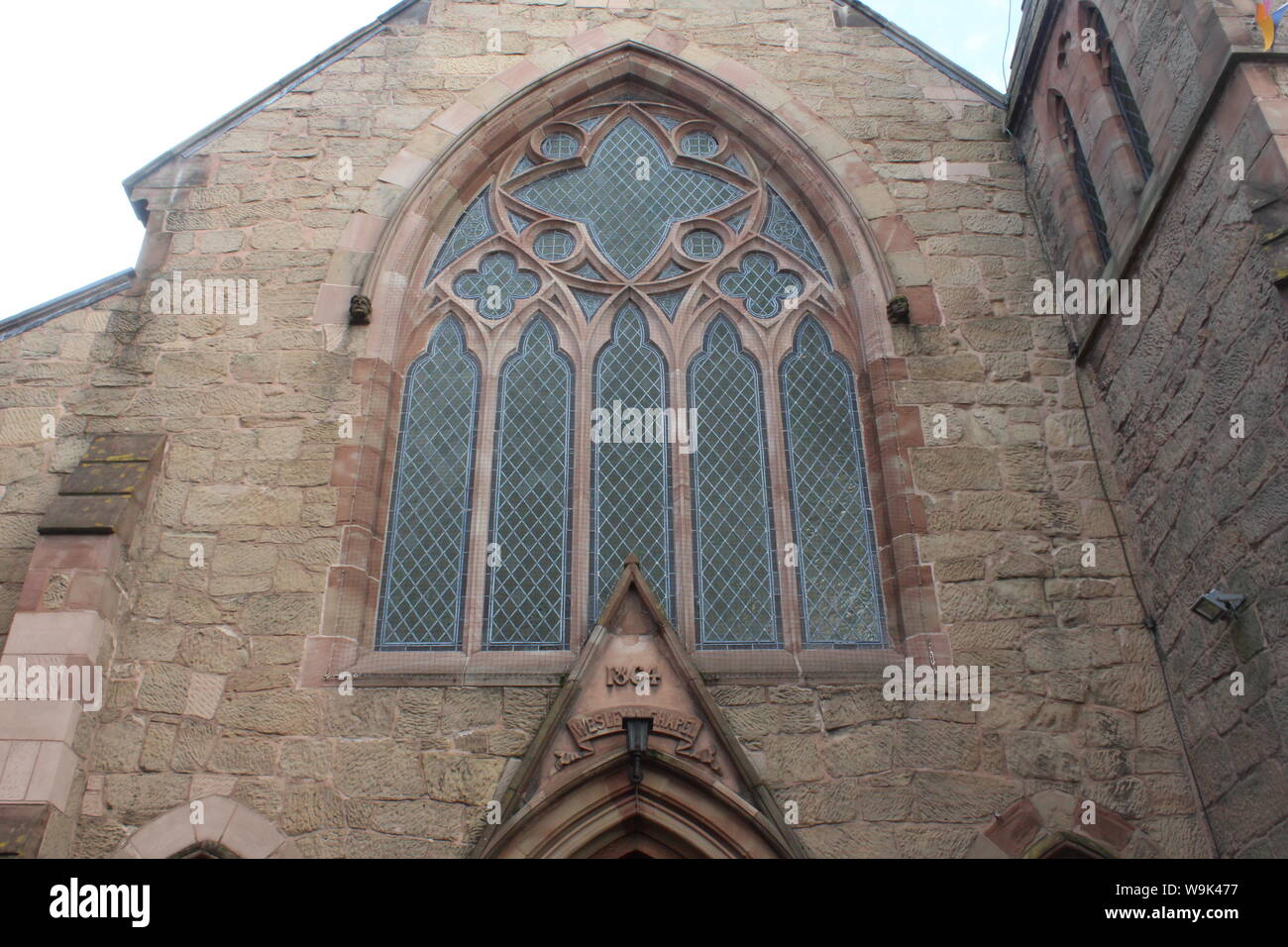 Image of the beautifully designed huge window in the Knutsford methodist church on a cloudy day Stock Photo