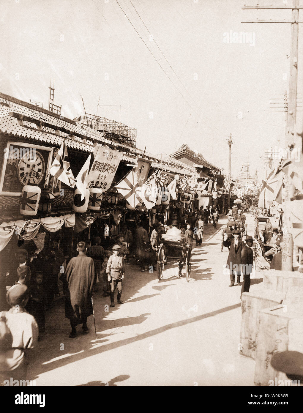 [ 1900s Japan - Shinsaibashi Shopping Street in Osaka ] —   Shinsaibashi shopping street in Osaka. In the far back, the Ishihara Watch Shop (石原時計商舗) is faintly visible.  20th century vintage albumen photograph. Stock Photo