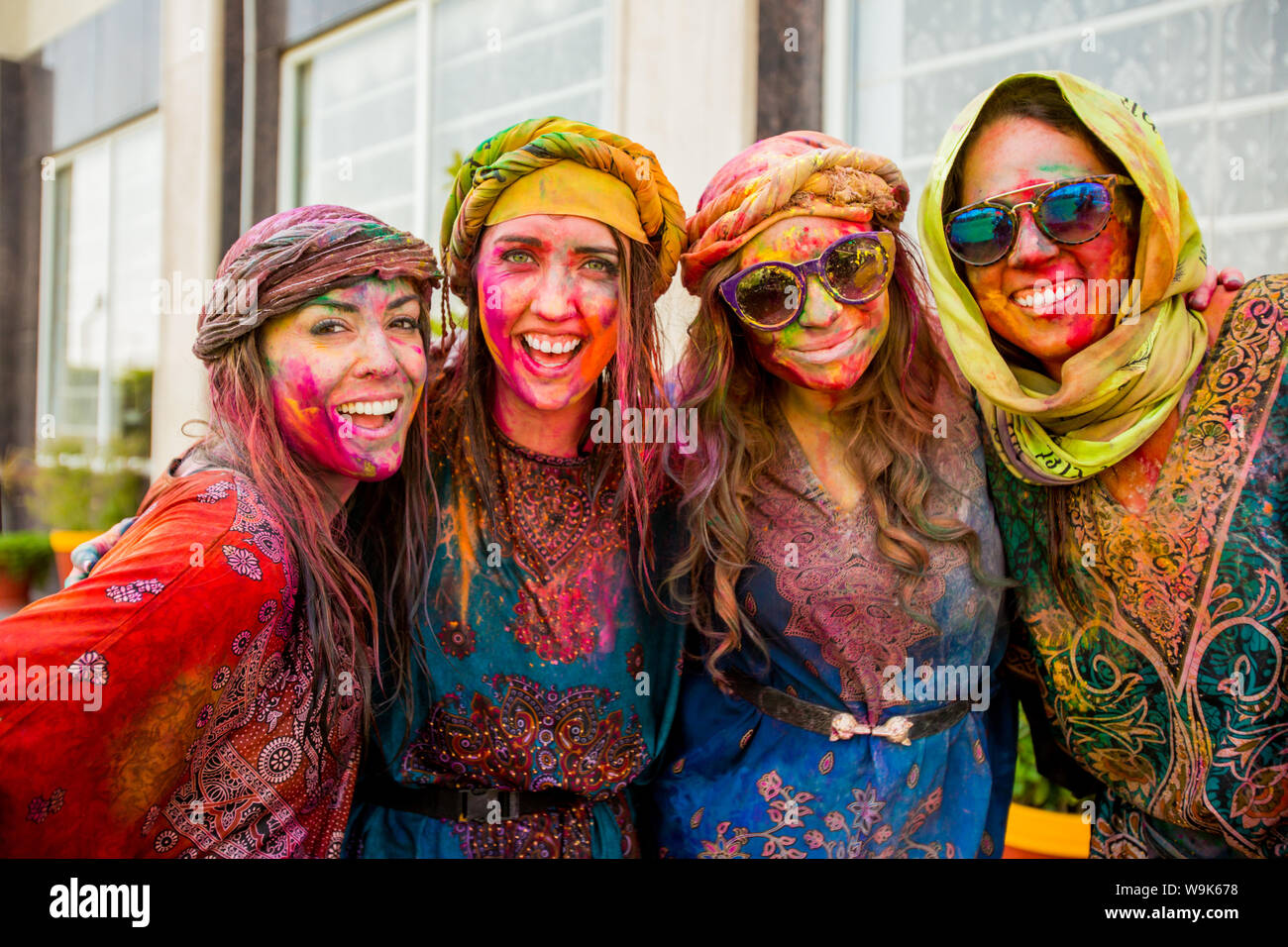Tourists covered in pigment during the Holi Festival, Vrindavan, India, Asia Stock Photo