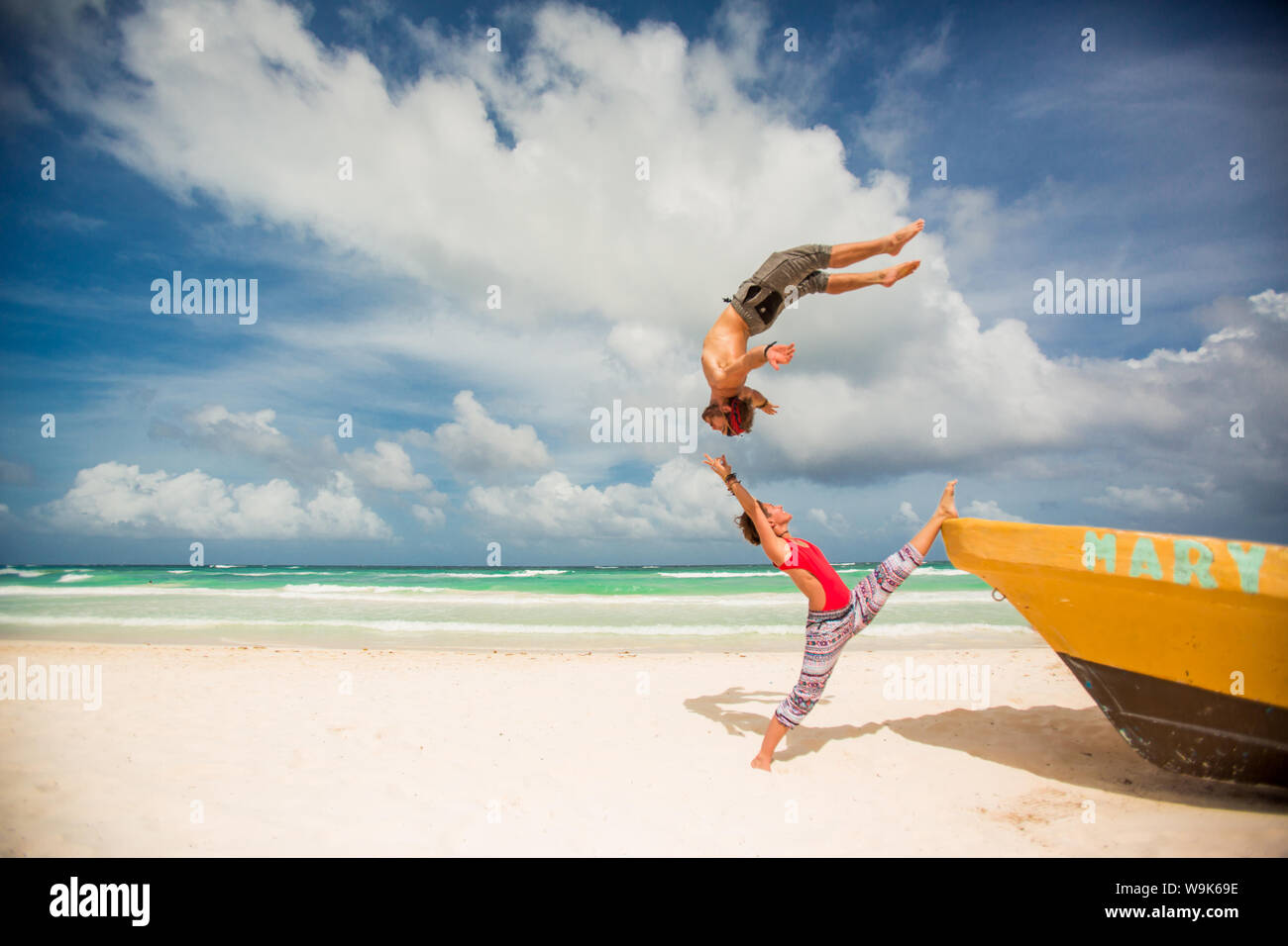 Acrobatic Couple Balancing Together On The Beach Of Tulum Mexico acrobatic-couple-balancing-together-on-the-beach-of-tulum-mexico