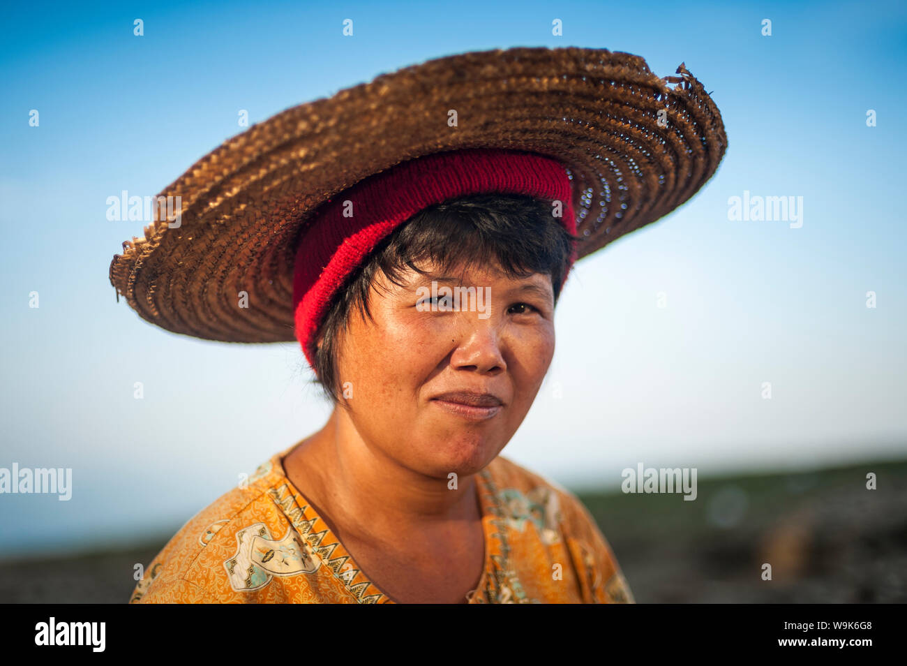 A Burmese woman panning for gold in a small stream near Putao stops to have her portrait taken, Kachin State, Myanmar (Burma), Asia Stock Photo