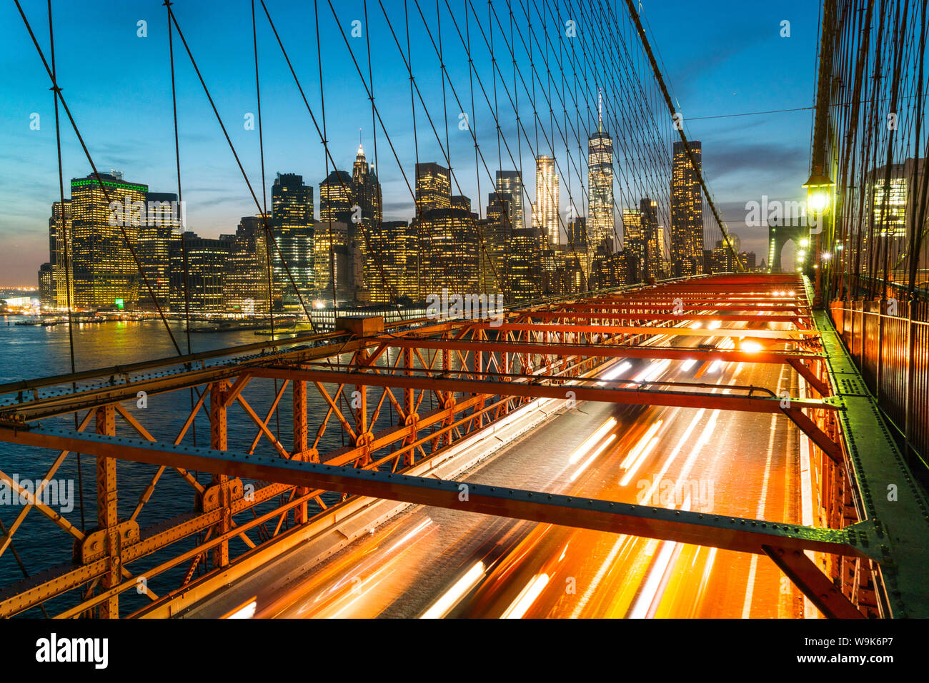 Rush hour traffic at night on Brooklyn Bridge and Manhattan skyline beyond, New York City, United States of America, North America Stock Photo