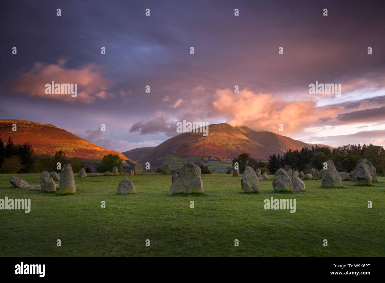 Castlerigg Stone Circle in autumn at sunrise with Blencathra bathed in dramatic dawn light, Lake District National Park, Cumbria, England, UK Stock Photo