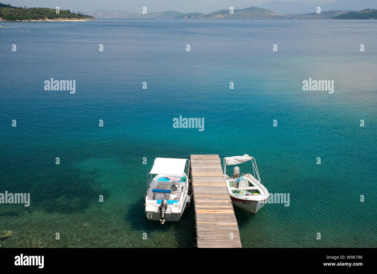 Speedboats tied up at a dock in Kouloura Harbour on the northeast coast of Corfu, Ionian Islands, Greek Islands, Greece, Europe Stock Photo