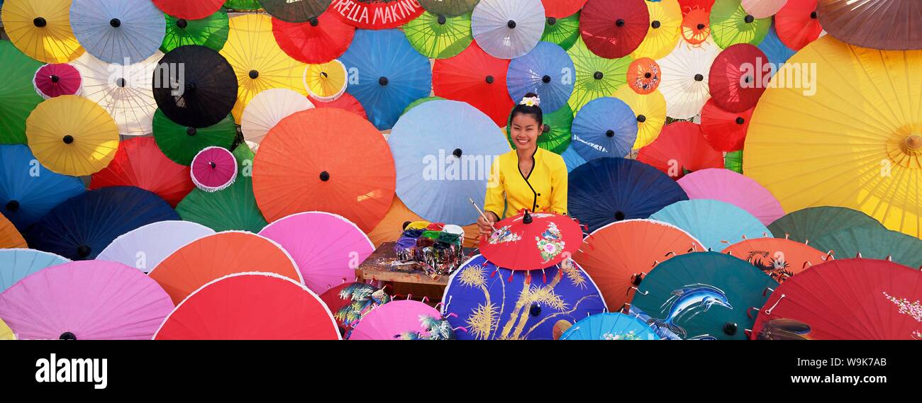 Woman painting umbrellas, umbrella making factory, Bo Sang umbrella village, Bo Sang, Chiang Mai, northern Thailand, Thailand, Southeast Asia, Asia Stock Photo