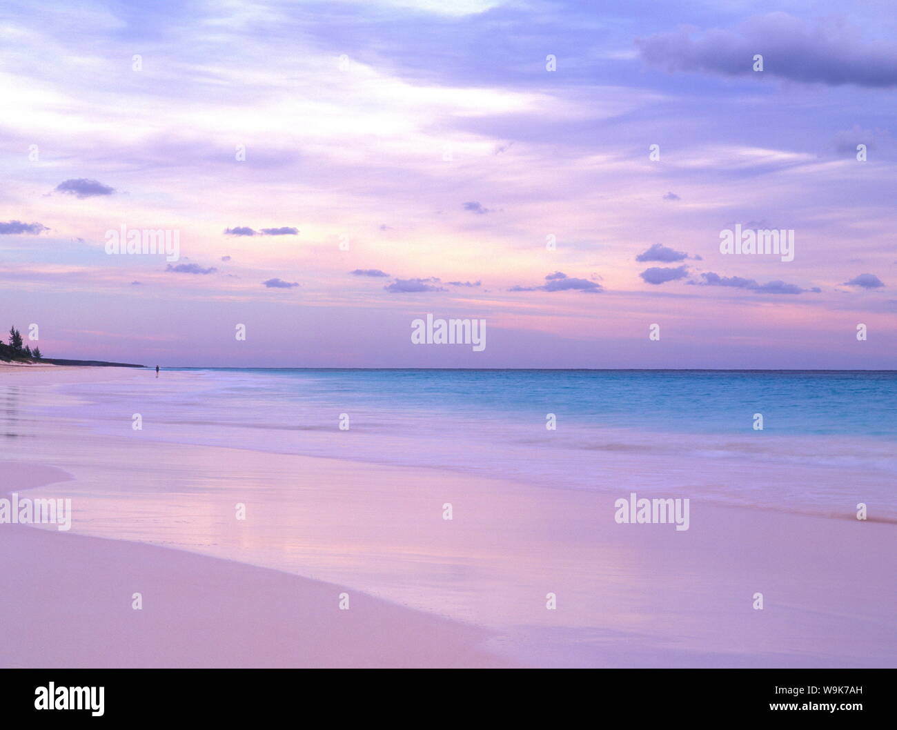 Pink Sands Beach at dusk with a person in the distance, Harbour Island, Eleuthera, The Bahamas, West Indies, Atlantic, Central America Stock Photo