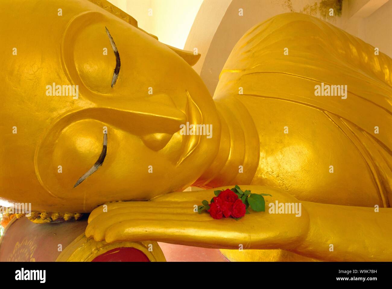 Close up of the head of a reclining Buddha statue, Wat Pha Baat Tai, Luang Prabang, Laos Stock Photo