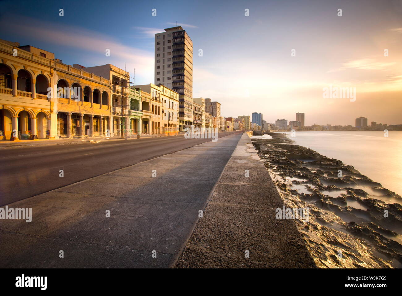 View along The Malecon at dusk showing mix of old and new buildings, Havana, Cuba, West Indies, Central America Stock Photo