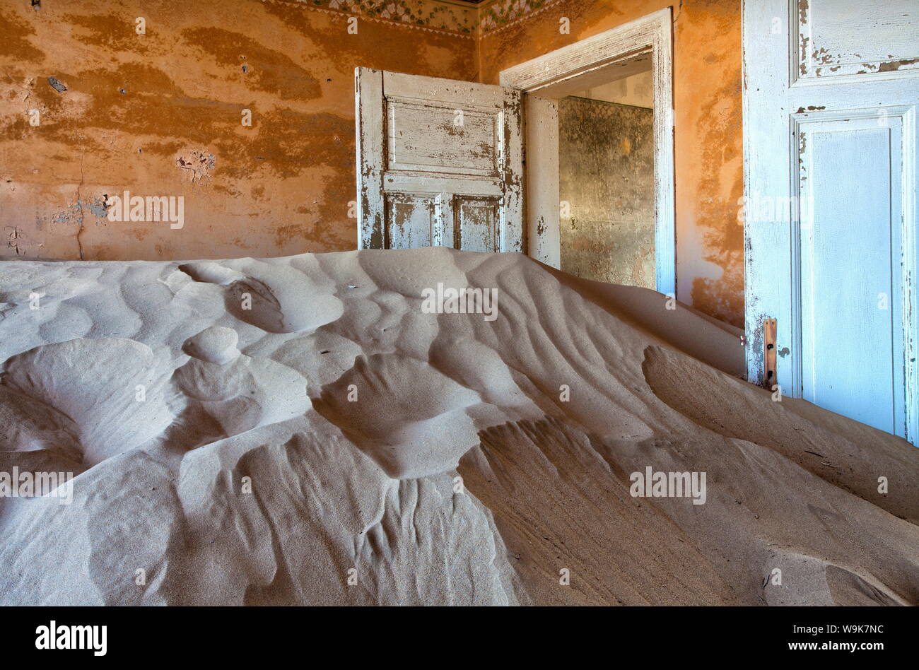 Interior of building slowly being consumed by the sands of the Namib Desert in the town of Kolmanskop, Forbidden Diamond Area near Luderitz, Namibia Stock Photo