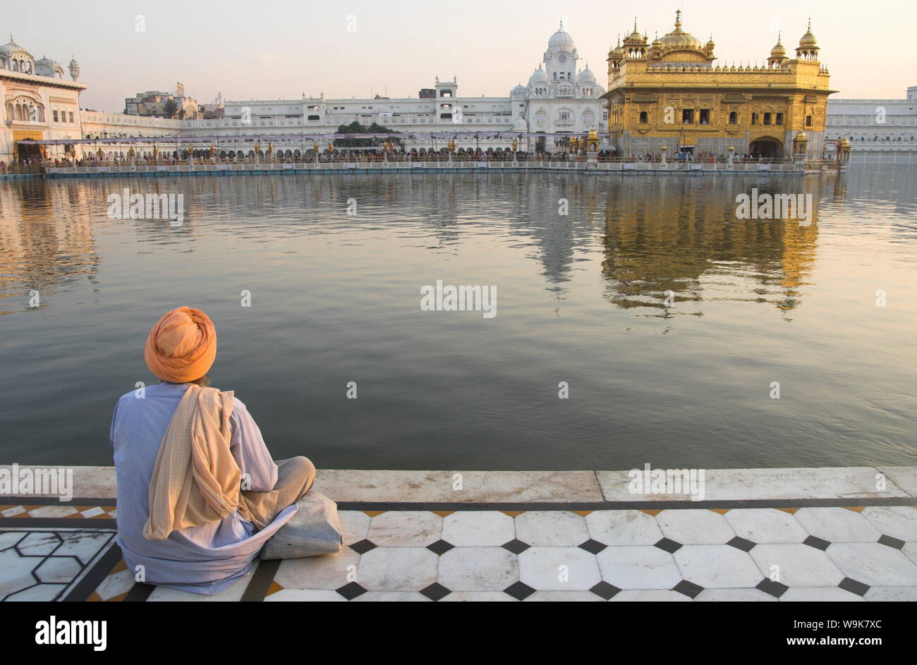 Sikh pilgrim sitting by holy pool, Golden Temple, Amritsar, Punjab state, India, Asia Stock Photo