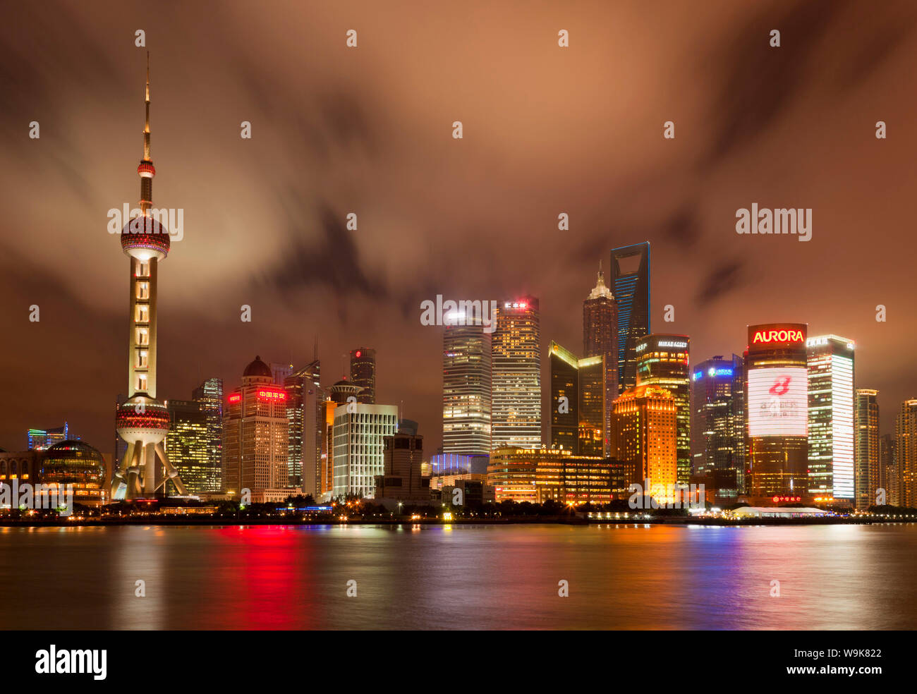 City skyline at night with Oriental Pearl Tower and Pudong skyscrapers across the Huangpu River, Shanghai, China, Asia Stock Photo