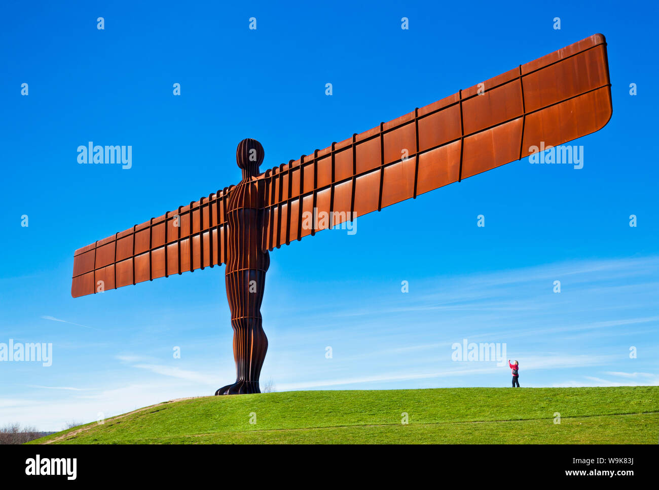 Person photographing the Angel of the North sculpture by Antony Gormley, Gateshead, Newcastle-upon-Tyne, Tyne and Wear, England, United Kingdom Stock Photo