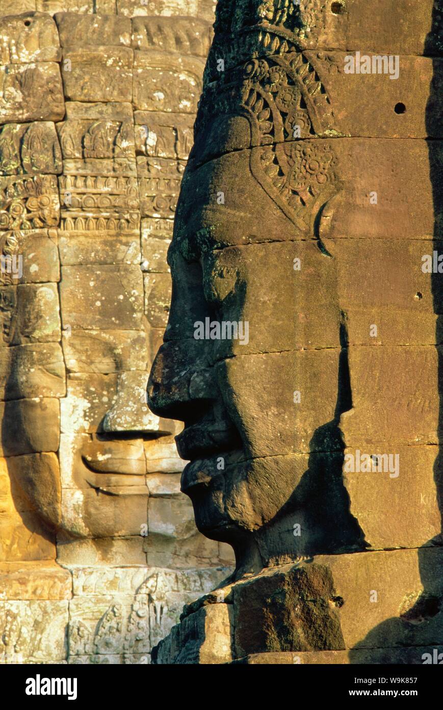 Stone heads typifying Cambodia on the Bayon Temple at Angkor Wat, Siem Reap, Cambodia, Asia. Stock Photo