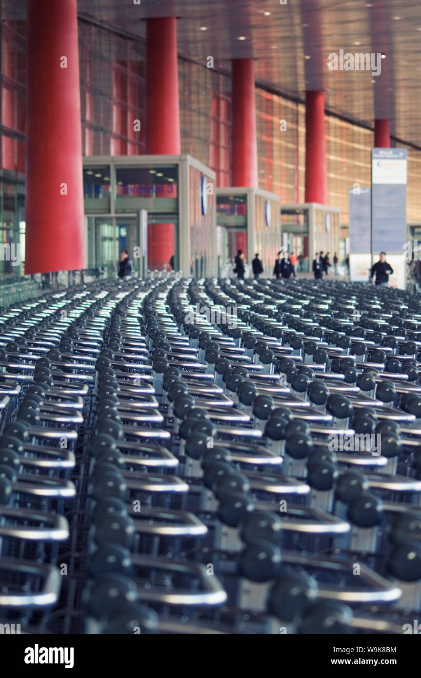 Hundreds of trolleys at Beijing Capital Airport, part of the new Terminal building, second largest building in the world, Beijing, China Stock Photo