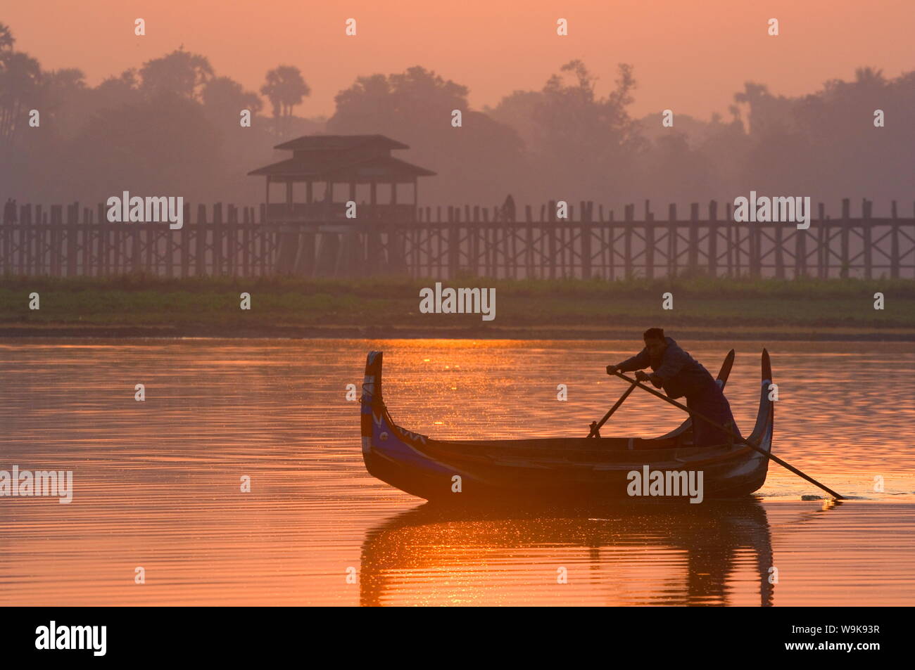 Boat on Thaungthaman Lake, and U Bein's Bridge, at 1.2 km long the world's longest teak bridge, Amarapura, Myanmar (Burma), Asia Stock Photo