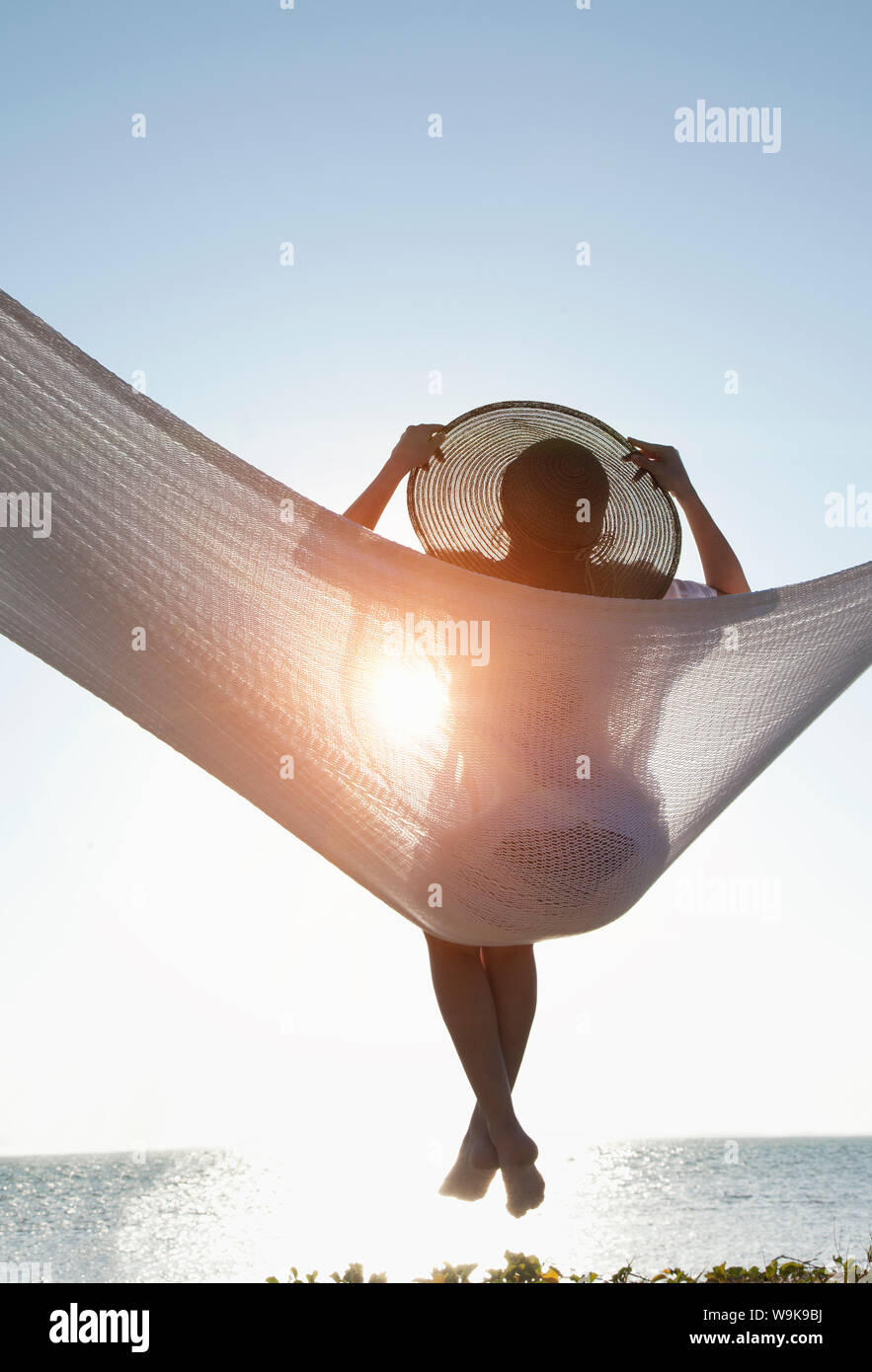 Woman in a hammock on the beach, Florida, United States of America, North America Stock Photo