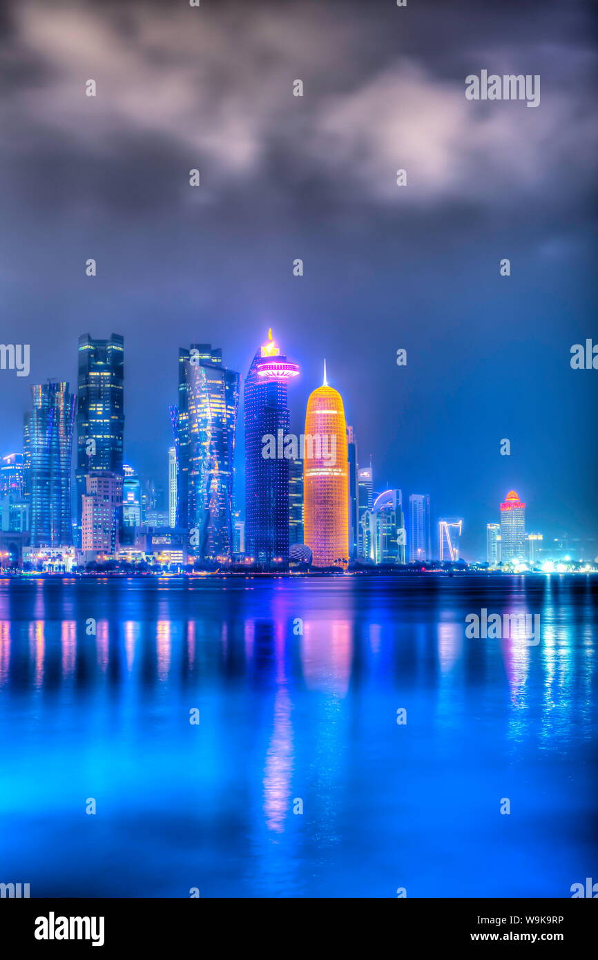 New skyline of the West Bay central financial district of Doha, illuminated at dusk, Qatar, Middle East Stock Photo