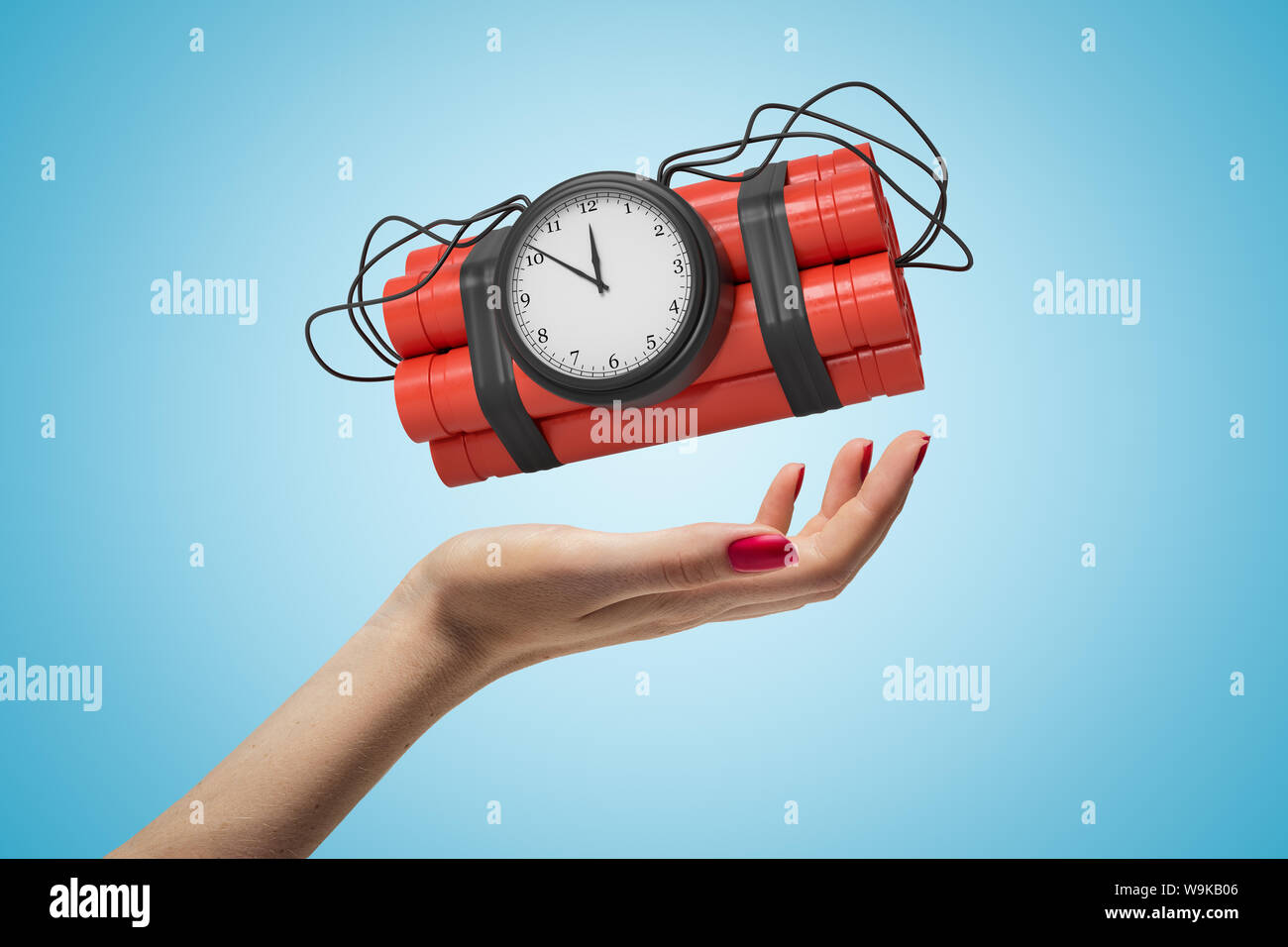 Female hand holding red dynamite stick time bomb on blue background Stock Photo