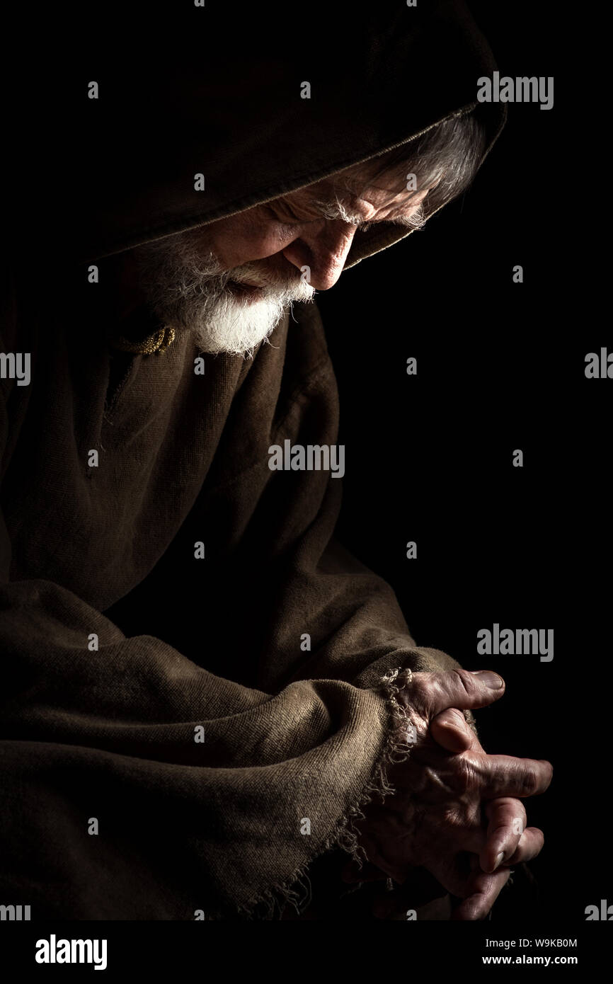 Medieval Monk in prayer Stock Photo