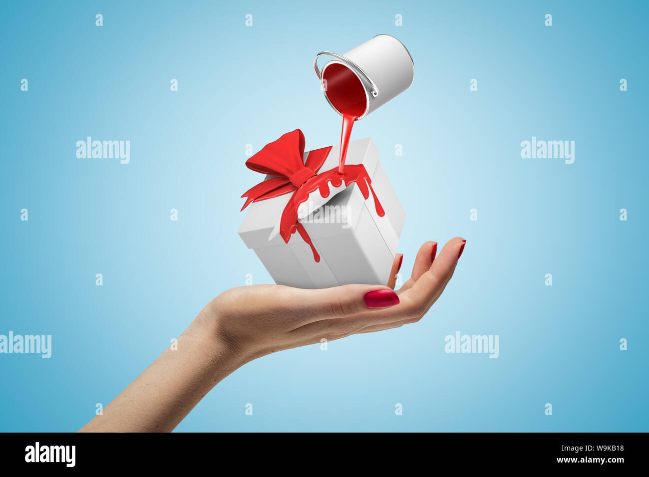Female hand with red paint bucket turned upside down above white gift box on blue background Stock Photo