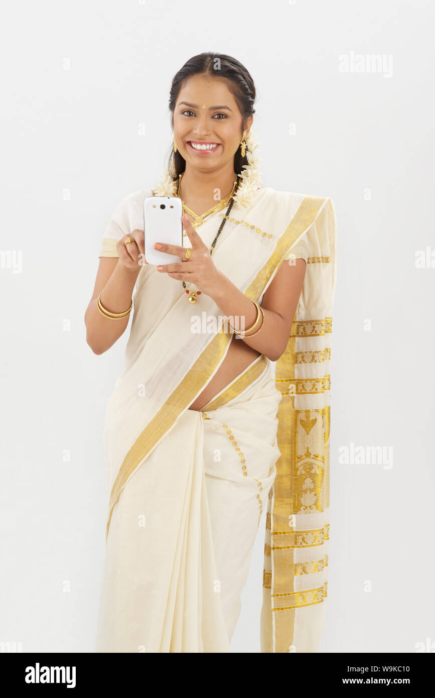 South Indian woman text messaging on a mobile phone Stock Photo - Alamy