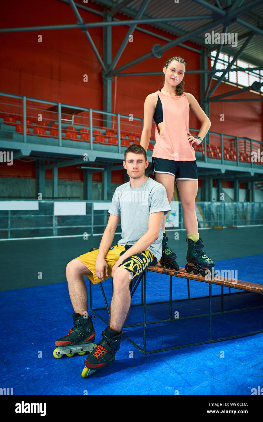 Girl and boy on rollerblades in skate park Stock Photo Alamy