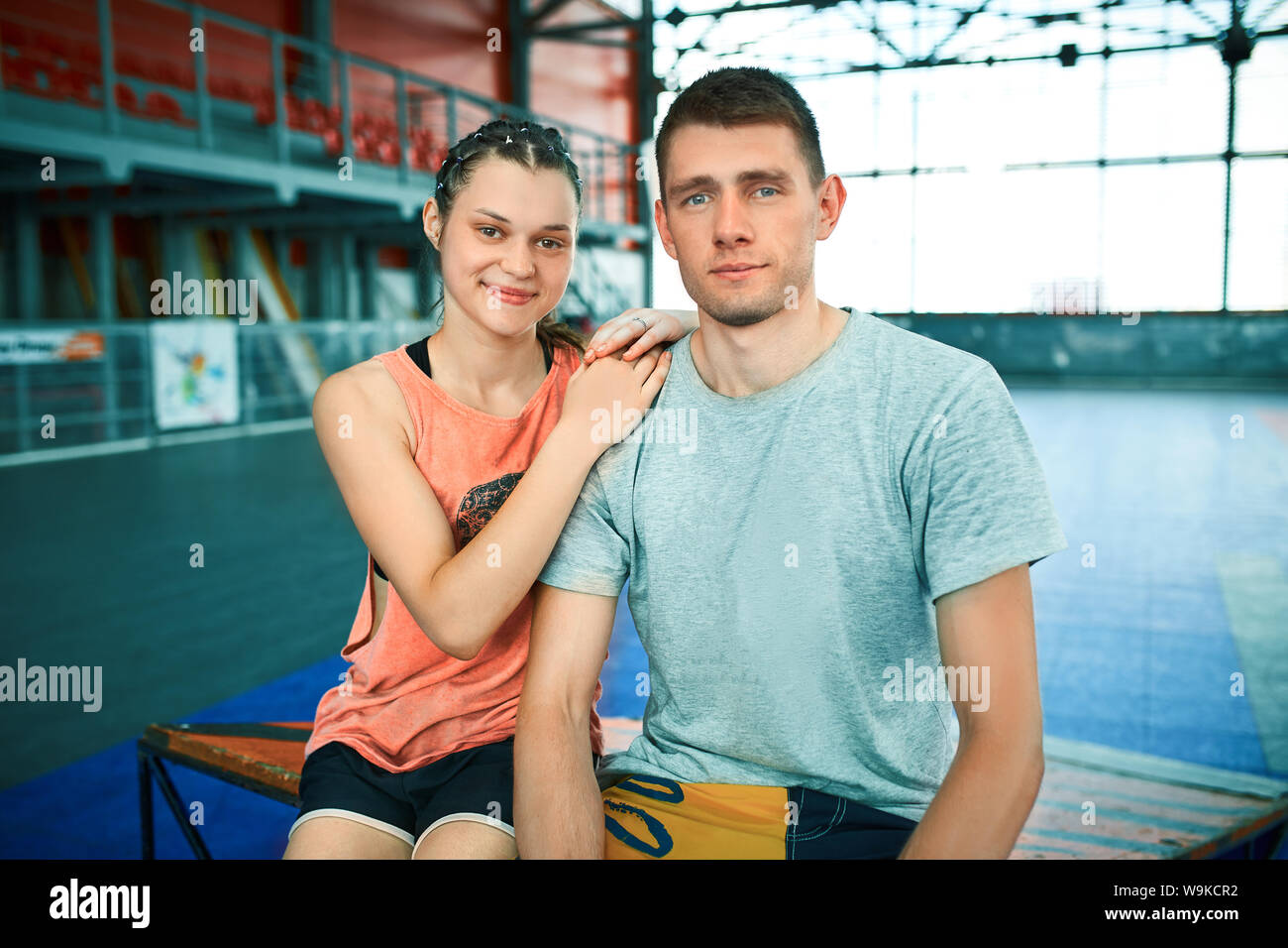 Girl and boy on rollerblades in skate park Stock Photo