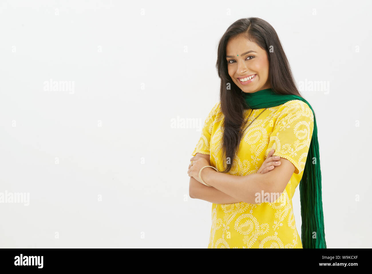 Young woman smiling with her arms crossed Stock Photo - Alamy