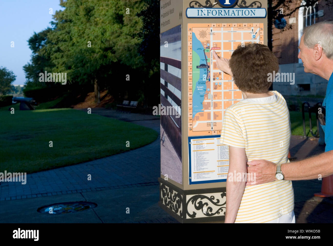 Caucasian Senior Couple  (age 60-70) Reading Information Sign at  Georgetown SC, USA. Stock Photo