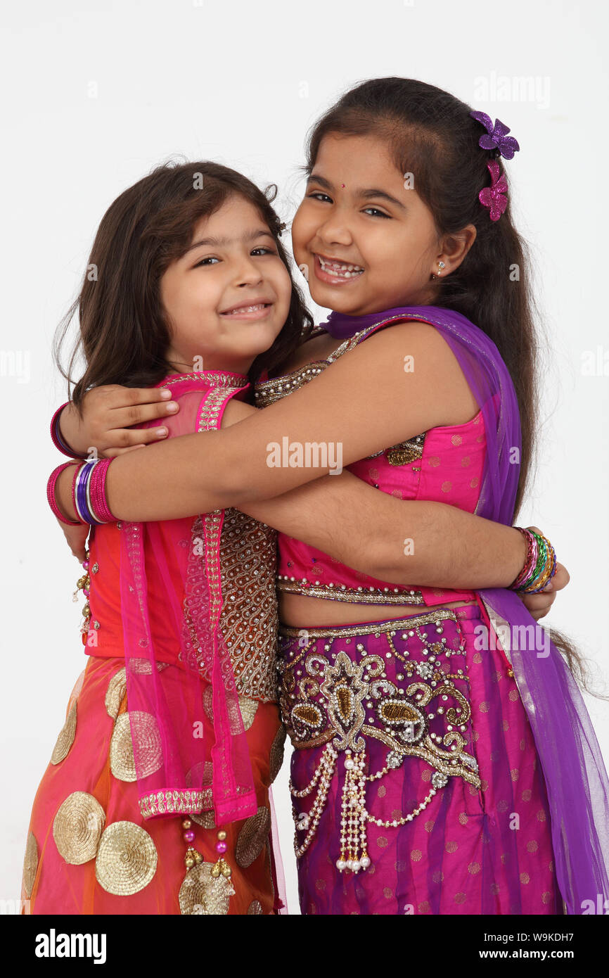 Two girls hugging each other and smiling Stock Photo - Alamy