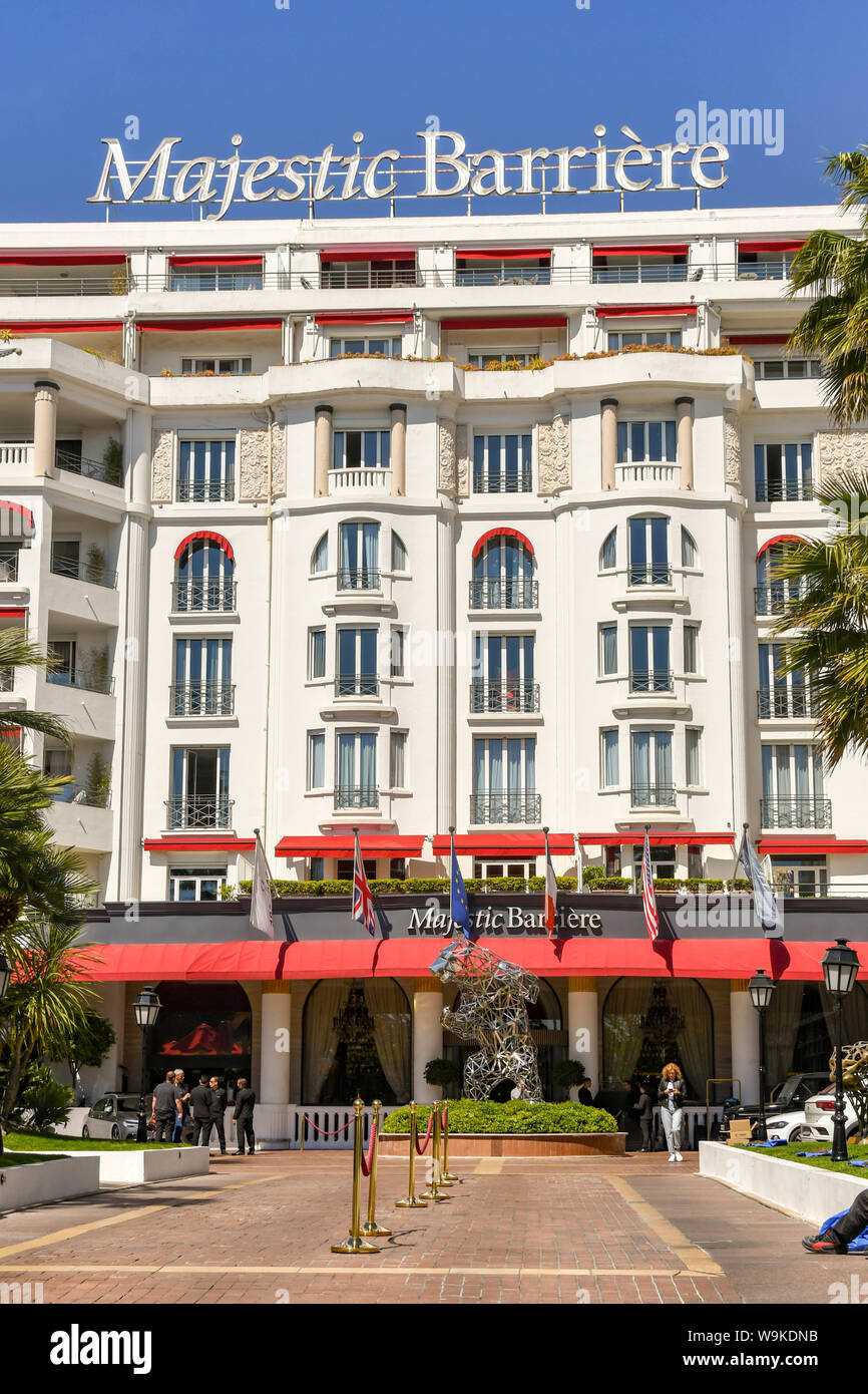 CANNES, FRANCE - APRIL 2019: Front exterior view of the Majestic Barriere hotel, which is a landmark on the seafront in Cannes. Stock Photo