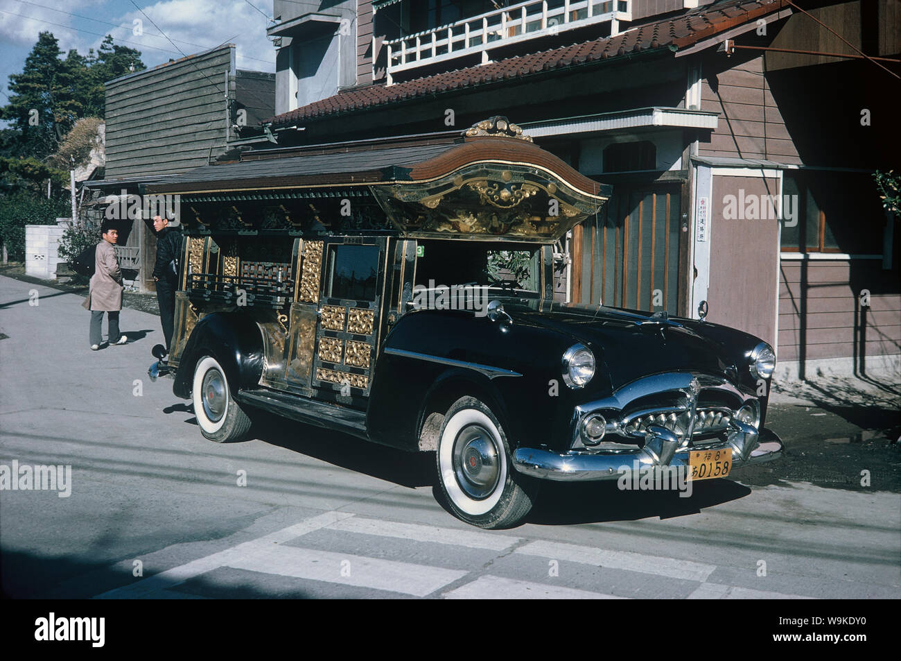 [ 1960s Japan - Japanese Hearse ] —   Cadillac transformed into an elaborately decorated Japanese hearse, 1964 (Showa 39).  20th century vintage slide film. Stock Photo