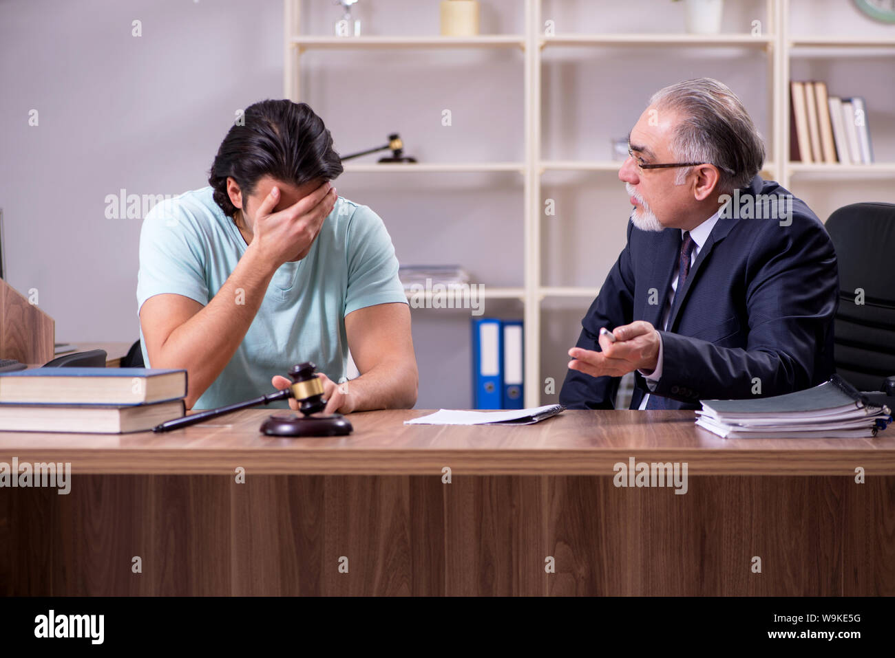 The young man visiting experienced male lawyer Stock Photo