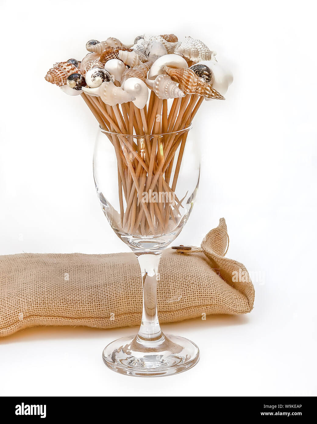 Decorative cocktail picks in a crystal glass. White background Stock