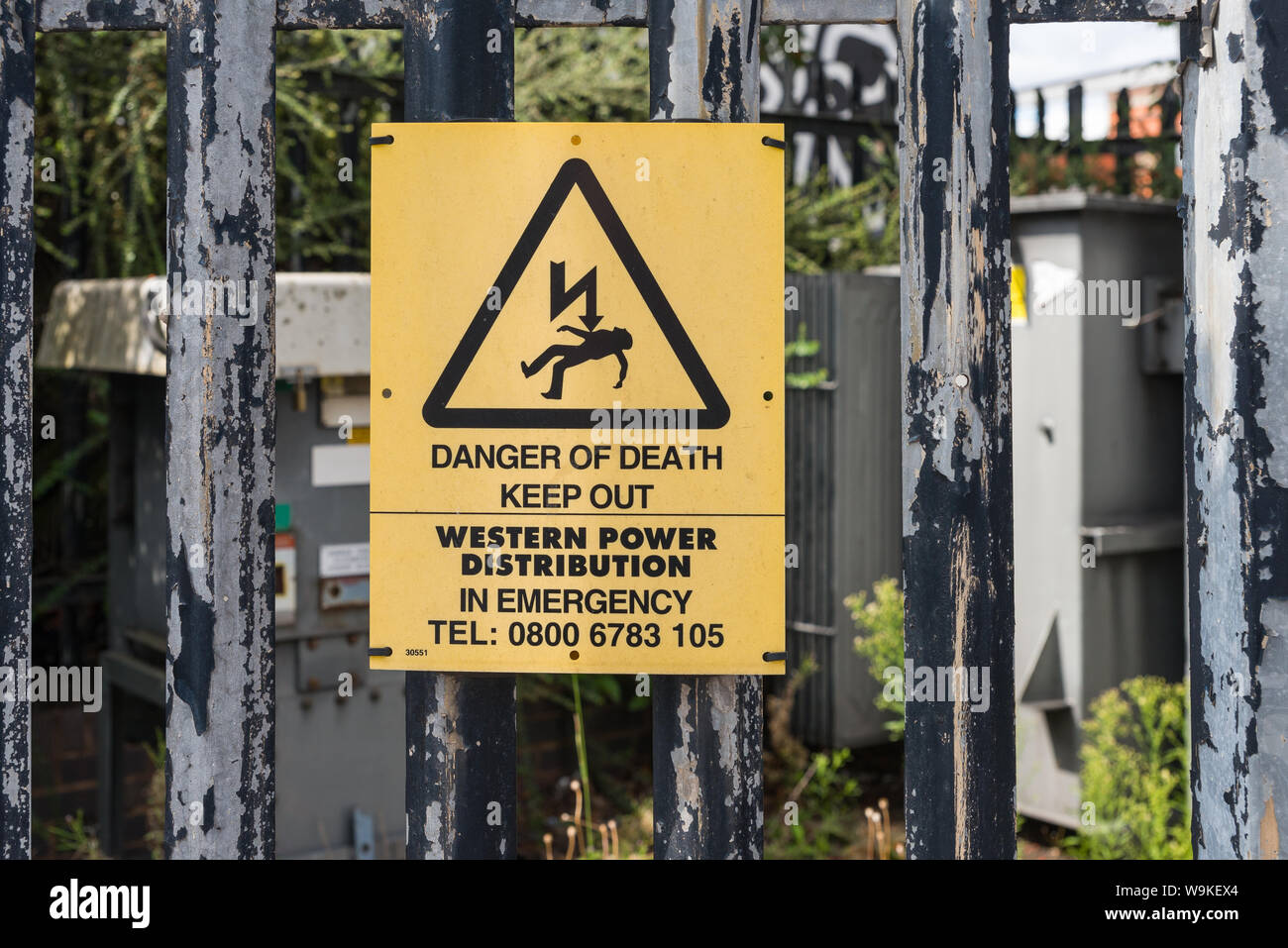 Yellow warning sign outside Western Power Distribution electricity sub-station saying Keep Out, Danger of Death Stock Photo
