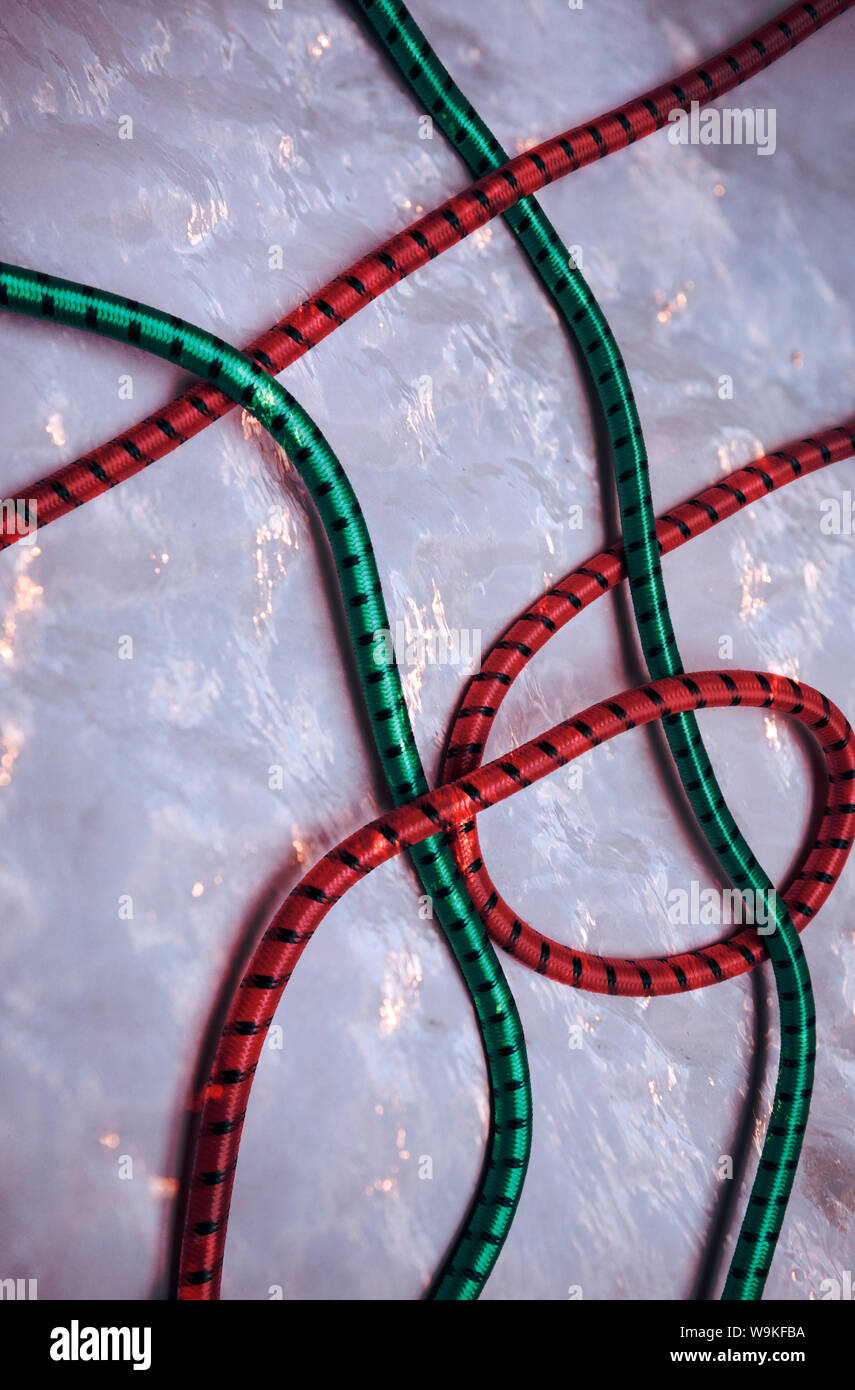 red and green climbing ropes against a wall of ice.  full frame.  possible book cover. Stock Photo